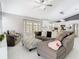 Cozy living room with modern furnishings, open to a well-appointed kitchen and access to the outdoor space at 7974 Village Green Rd, Orlando, FL 32818