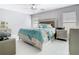 Serene primary bedroom with a decorative ceiling fan, large windows, and stylish bedding, providing a restful retreat at 7974 Village Green Rd, Orlando, FL 32818
