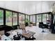 Sun Room featuring tile flooring, large windows, seating, and salon equipment at 7974 Village Green Rd, Orlando, FL 32818