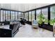 Sunroom featuring tile flooring, large windows, seating, and lots of sunlight at 7974 Village Green Rd, Orlando, FL 32818
