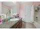 Cozy bathroom with vanity, mirror, walk in shower, and tub at 8067 Crushed Pepper Ave, Orlando, FL 32817