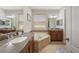 Bathroom with dual sinks, a soaking tub, and ample counter space at 8067 Crushed Pepper Ave, Orlando, FL 32817