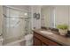 Bright bathroom featuring a glass-enclosed shower and granite countertop at 8067 Crushed Pepper Ave, Orlando, FL 32817