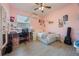 Charming pink bedroom with a ceiling fan, desk, and ample space for personalization at 8067 Crushed Pepper Ave, Orlando, FL 32817