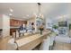 Open-concept dining area with a view of the kitchen, living room, and outdoor patio at 8067 Crushed Pepper Ave, Orlando, FL 32817
