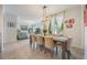 Elegant dining room with a long wooden table, seating for eight, and views of the living room at 8067 Crushed Pepper Ave, Orlando, FL 32817