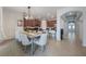 Bright dining room adjacent to the kitchen features a large table and white chairs at 8067 Crushed Pepper Ave, Orlando, FL 32817