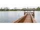 Community wooden dock extending into a serene lake at 8067 Crushed Pepper Ave, Orlando, FL 32817