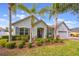 Beautiful home with lush landscaping, palm trees and a gray front door at 8067 Crushed Pepper Ave, Orlando, FL 32817