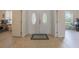 Inviting foyer featuring a double door entry, neutral tile flooring, and open access to other rooms at 8067 Crushed Pepper Ave, Orlando, FL 32817