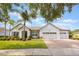 Charming single-story home with a three-car garage, mature landscaping, and a brick paver driveway at 8067 Crushed Pepper Ave, Orlando, FL 32817
