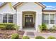 Charming front porch featuring a gray double door and manicured landscaping at 8067 Crushed Pepper Ave, Orlando, FL 32817