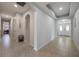 Bright hallway featuring tile floors, archways and entry door with sidelights at 8067 Crushed Pepper Ave, Orlando, FL 32817