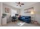 Bright home office with a comfortable sofa, a large window, and a modern workspace at 8067 Crushed Pepper Ave, Orlando, FL 32817