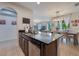 Kitchen island with a sink and bar seating overlooks the dining area at 8067 Crushed Pepper Ave, Orlando, FL 32817