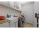 Well organized laundry room with washer, dryer, storage, and utility sink at 8067 Crushed Pepper Ave, Orlando, FL 32817