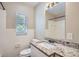 Bathroom featuring a granite countertop and white tile at 811 S Lone Oak Dr, Leesburg, FL 34748