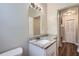 Bathroom featuring granite countertop and modern light fixture at 811 S Lone Oak Dr, Leesburg, FL 34748