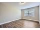 This bedroom has a window and wood-look laminate flooring at 811 S Lone Oak Dr, Leesburg, FL 34748