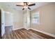 Room with modern ceiling fan, a window with blinds, and a doorway into another room at 811 S Lone Oak Dr, Leesburg, FL 34748