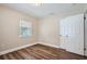Bedroom featuring laminate flooring, neutral walls, and a window at 811 S Lone Oak Dr, Leesburg, FL 34748