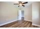 Bright bedroom has attractive flooring, a neutral color scheme, and an open doorway at 811 S Lone Oak Dr, Leesburg, FL 34748
