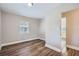Bright bedroom with wood-look flooring and a window with blinds allowing lots of natural light at 811 S Lone Oak Dr, Leesburg, FL 34748