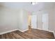 A well-lit room features modern flooring and two doors, one leading to another room at 811 S Lone Oak Dr, Leesburg, FL 34748