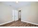 Bedroom features laminate flooring and closet with sliding doors at 811 S Lone Oak Dr, Leesburg, FL 34748