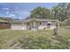Back view of a cozy home showcasing its simple design and well-maintained surroundings at 811 S Lone Oak Dr, Leesburg, FL 34748