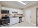 Modern kitchen features white cabinets, stainless steel appliances, and granite countertops at 811 S Lone Oak Dr, Leesburg, FL 34748