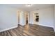 Living room featuring laminate floors, neutral paint and multiple entryways at 811 S Lone Oak Dr, Leesburg, FL 34748