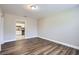 Open living space featuring laminate floors and white trim at 811 S Lone Oak Dr, Leesburg, FL 34748
