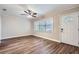 Living room featuring new flooring, a ceiling fan, and a large window for natural light at 811 S Lone Oak Dr, Leesburg, FL 34748