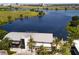 Aerial view of lakeside restaurant Canvas, with palm trees and outdoor seating at 8268 Bellow St, Orlando, FL 32827