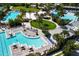 Aerial view showcasing community pools, a sandy beach, and recreational areas at 8268 Bellow St, Orlando, FL 32827