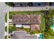 Aerial shot of a home with a tiled roof, neatly landscaped yard, and a paved driveway at 8268 Bellow St, Orlando, FL 32827
