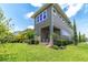 Expansive backyard featuring lush green grass, well-manicured bushes, and a charming two-story home at 8268 Bellow St, Orlando, FL 32827