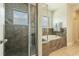Modern bathroom featuring a glass shower and a soaking tub with tile surround and decorative accents at 8268 Bellow St, Orlando, FL 32827