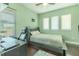 Well-lit bedroom with a desk, a ceiling fan, and natural light from the windows at 8268 Bellow St, Orlando, FL 32827