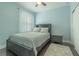Cozy bedroom with a ceiling fan, wooden floors, and natural light from the window at 8268 Bellow St, Orlando, FL 32827