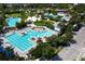 An aerial view features the community pool, lounge seating, landscaping, and nearby parking at 8268 Bellow St, Orlando, FL 32827