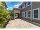 Exterior view of a home with a paved driveway, lush landscaping, and a covered carport entry at 8268 Bellow St, Orlando, FL 32827