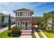 Charming two-story home featuring a lovely portico, arched car port, clay tile roof and beautiful landscaping at 8268 Bellow St, Orlando, FL 32827