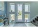 Bright foyer with tile floors, sidelight windows, stairs, and charming decor at 8268 Bellow St, Orlando, FL 32827