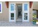 A bright foyer with large sidelight windows and stylish front door at 8268 Bellow St, Orlando, FL 32827