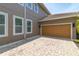 Spacious two-car garage with brick-paved driveway and lush landscaping at 8268 Bellow St, Orlando, FL 32827