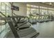 Bright gym area with cardio equipment and large windows overlooking green landscaping at 8268 Bellow St, Orlando, FL 32827