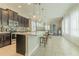 Open kitchen with an island, pendant lighting, and stainless steel appliances at 8268 Bellow St, Orlando, FL 32827