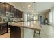 Spacious kitchen with stainless steel appliances, a large island, dark wood cabinets, and decorative pendant lighting at 8268 Bellow St, Orlando, FL 32827